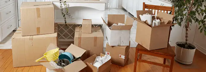 Packed moving boxes and household items in a kitchen before move-out or move-in cleaning, Henderson, NV.